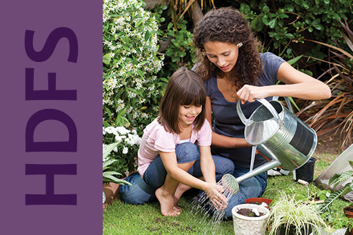 Adult and child watering plants